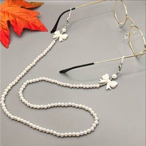 Eyeglass necklace holders, one black and  white and one white